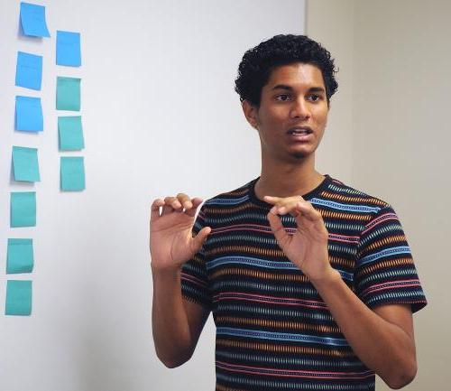 A student leads a group discussion and brainstorming session.