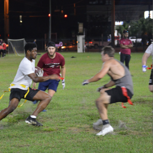 Students attempt to grab the ball carriers flag during an intramural flag football game